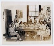 Photograph of children at a table piled with books at the Athens Regional Library, Dunbar Branch, Athens, Georgia, 1945 July