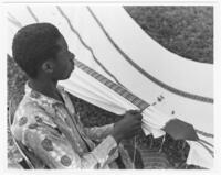 Young Man Stitching a Hammock, circa 1972