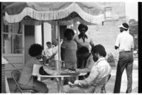 Group of People Sit Outside of a Polling Location, circa 1975
