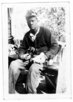 Unidentified Man with Puppy, circa 1940