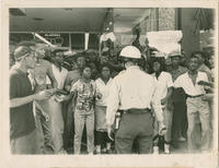 Birmingham Policeman Stands in Front of a Crowd, May 1963