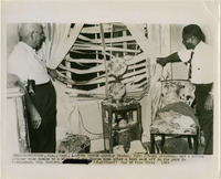 Arthur Shores and a Policeman View Bomb Damage To Home, 1963