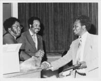 Reverend Nimrod Q. Reynolds and John Nettles Presenting an Award to Dr. Francis J. Kitele, July 1981