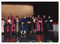Thomas W. Cole, Jr., John Henrik Clarke and Other Men and Women on Stage at Commencement, 1993