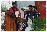 Hank Aaron with Thomas W. Cole, Jr. and an Unidentified Woman and Man on Stage at Commencement, 2000