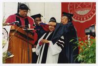 Xernona Clayton with Thomas W. Cole, Jr. and an Unidentified Woman and Man on Stage at Commencement, 2000