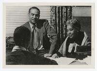 Three Unidentified Faculty/Staff Members in an Office, circa 1950