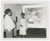 Two Unidentified Women with a Painting at an Art Exhibit, circa 1965