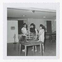 Unidentified Man and Two Women with a Sculpture at an Art Exhibit, circa 1965