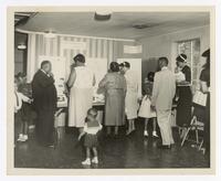 An Unidentified Men, Women, and Children View Poster Display at Christian Education Week, circa 1931
