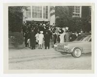 Men and Women Gather Outside of a Building at a Baccalaureate Event, circa 1965