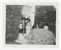 Men and Women Gather Outside of a Building at a Baccalaureate Event, circa 1965