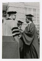 An Unidentified Graduate Receives His Diploma at Commencement, circa 1970