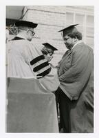 An Unidentified Graduate Receives His Diploma at Commencement, circa 1970