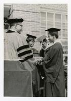 An Unidentified Graduate Receives Her Diploma at Commencement, circa 1970