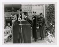 Vivian W. Henderson and Three Unidentified Men on Stage at Commencement, circa 1970