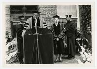Vivian W. Henderson With Two Men and a Woman on Stage at Commencement, circa 1970