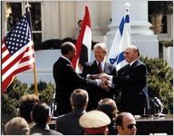 Presidents Carter and Sadat and Prime Minister Begin joined hands in celebration of the signing of the “Treaty of Peace Between the Arab Republic of Egypt and the State of Israel.”