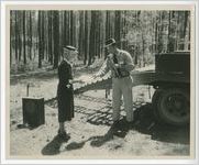 Photograph of woman and man with a microphone holding a certificate for tree farming, Columbia County, Georgia, 1952-1957?