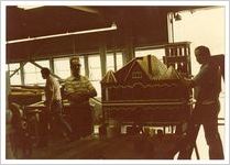 Photograph of men in a workshop standing next to a replica of a building, Clarkesville, Habersham County, Georgia