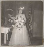 Photograph of a young woman holding a bouquet of flowers, Clarkesville, Habersham County, Georgia, 1953