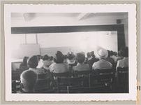 Photograph of women watching a presentation held inside an auditorium, Clarkesville, Habersham County, Georgia, 1953