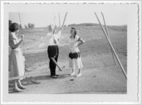 Photograph of a man and two women adjusting a swing, Clarkesville, Habersham County, Georgia, 1953