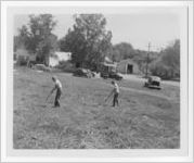 Photograph of two boys raking a lawn, Clarkesville, Habersham County, Georgia, 1953