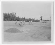 Photograph of men shoveling piles of dirt inside a large land clearing, Clarkesville, Habersham County, Georgia, 1953