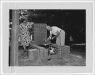 Photograph of a man and woman cooking at a barbecue grill, Clarkesville, Habersham County, Georgia, 1953
