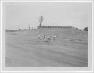 Photograph of men shoveling a pile of dirt inside a large land clearing, Clarkesville, Habersham County, Georgia, 1953