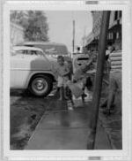 Photograph of young boys sweeping a sidewalk, Clarkesville, Habersham County, Georgia, 1953