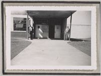 Photograph of two men standing in front of a building entrance, Clarkesville, Habersham County, Georgia, 1950