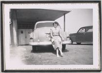 Photograph of a young woman seated on the back of an automobile, Clarkesville, Habersham County, Georgia, 1950