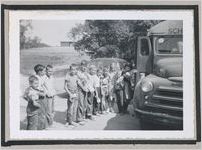 Photograph of a group of elementary school students lined up next to a school bus, Clarkesville, Habersham County, Georgia, 1950
