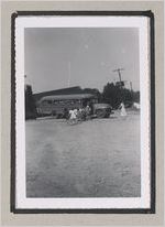 Photograph of a group of children running towards a schoolbus, Clarkesville, Habersham County, Georgia, 1950