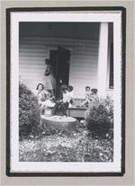 Photograph of children seated on a porch drinking beverages, Clarkesville, Habersham County, Georgia, 1950