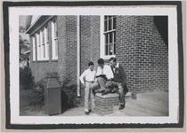 Photograph of three young men reading outside of a building, Clarkesville, Habersham County, Georgia, 1950