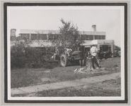 Photograph of men using a tractor to clear trees from the downtown area, Clarkesville, Habersham County, Georgia, 1950