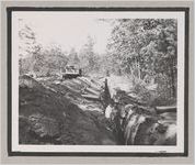 Photograph of two men standing in a trench next to pipe fittings, Clarkesville, Habersham County, Georgia, 1950