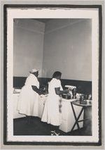 Photograph of two African American women cooking in a kitchen, Clarkesville, Habersham County, Georgia, 1950