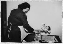 Photograph of a nurse weighing a baby, Clarkesville, Georgia, 1953