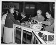 Photograph of women entering preserves for a canning contest at the Georgia State Fair, Macon, Bibb County, Georgia, 1954