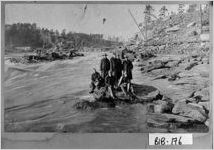 [Photograph of men on a boulder in the Ocmulgee River, Bibb County, Georgia, 1898 Dec.]