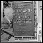 [Photograph of John H. Winder standing beside a plaque, Winder, Barrow County, Georgia, 1948?]