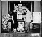 [Photograph of a woman showing a display, Moultrie, Colquitt County, Georgia, 195-]