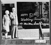 [Photograph of Mr. and Mrs. Sam Duggan standing outside of their business, Moultrie, Colquitt County, Georgia, 1976]