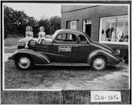 [Photograph of two children sitting on a car, Moultrie, Colquitt County, Georgia, 1940 or 1941]
