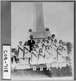 [Photograph of a group of young girls at a monument "To Our Confederate Dead"]