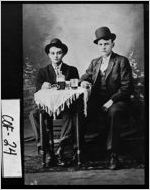 [Postcard of two young men sitting at a table, Douglas, Coffee County, Georgia, ca. 1915]